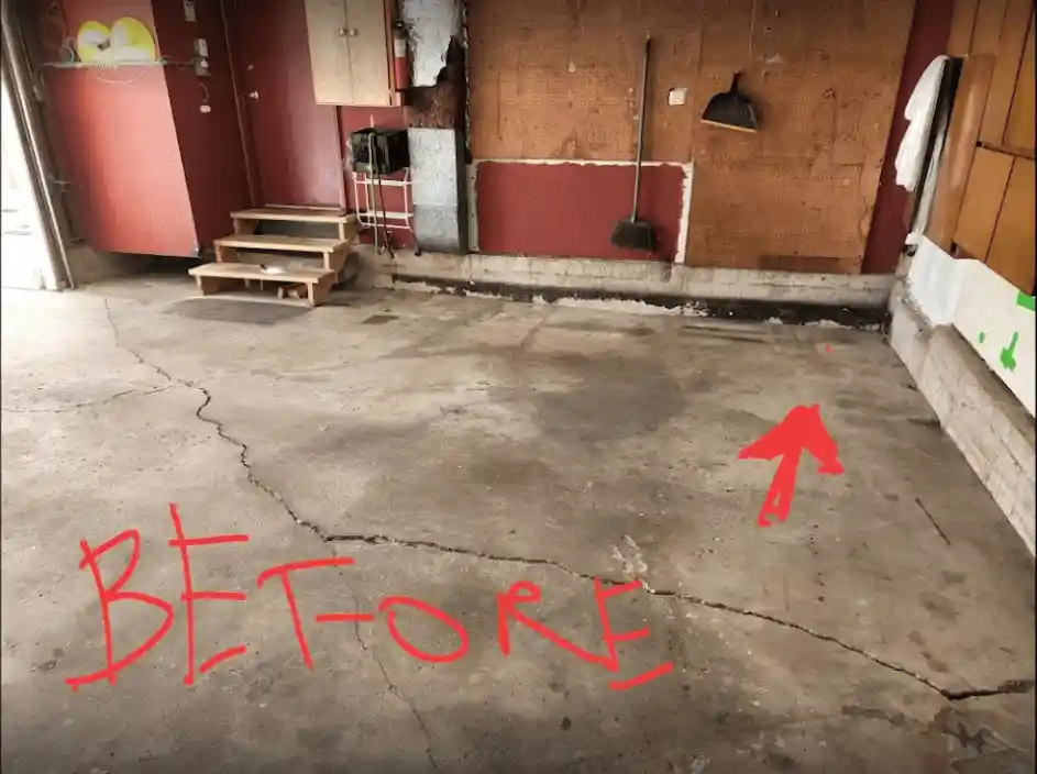 A cracked concrete garage floor with “BEFORE” in red and a red arrow points at the damage. Walls display cleaning tools and cabinets; wooden steps lead to a door on the left, highlighting our specialization in concrete lifting solutions.
